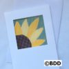 A card with a sunflower on it.