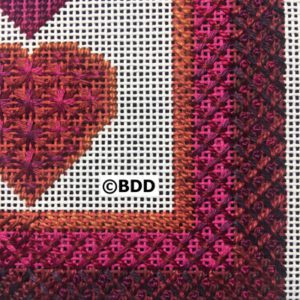 A close up of the heart on a cross stitch pattern