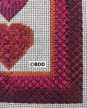 A close up of the heart on a cross stitch pattern