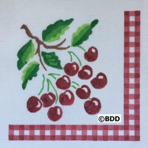 A red checkered napkin with cherries on it.