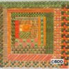 A square of green and orange fabric with a geometric design.