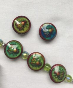 A bracelet with four buttons and a key chain.