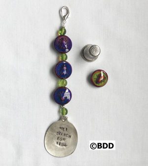 A key chain with beads and a silver spoon.