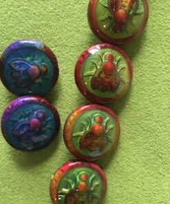 A group of six buttons with different designs on them.