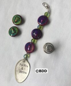 A spoon with a charm attached to it.