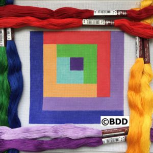 A square with different colors of yarn around it.