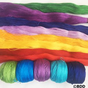 A group of yarn with different colors and sizes.