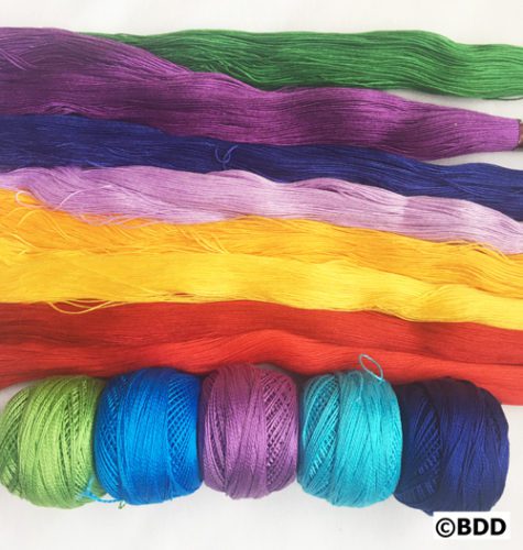 A group of yarn with different colors and sizes.