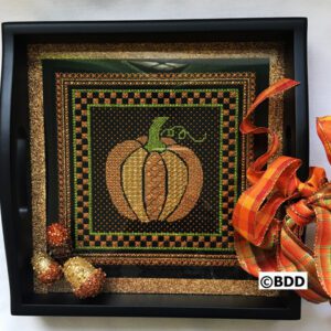 A black tray with a pumpkin on it