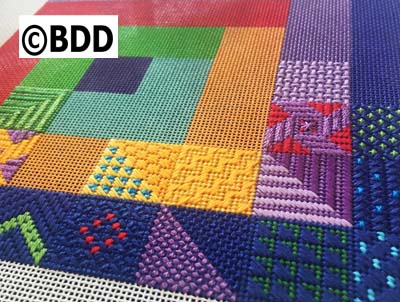 A close up of the colorful fabric with the words " bdd ".