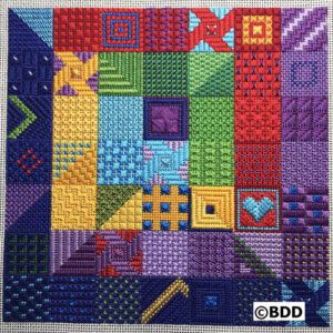 A colorful quilt with many different colors and designs.