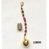 A gold bell with red beads hanging from it.