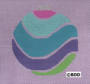 A purple background with a blue, green and pink ornament.