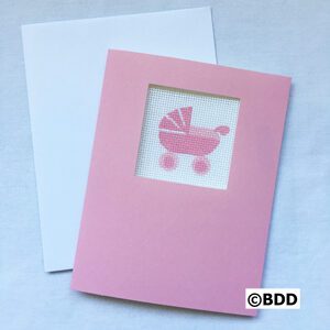 A pink card with a baby carriage on it.