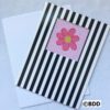 A card with a pink flower on it.