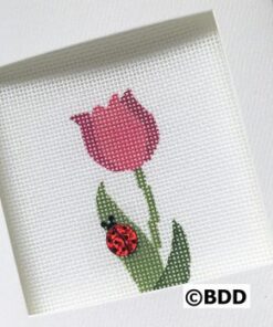 A cross stitch picture of a red flower and a ladybug.