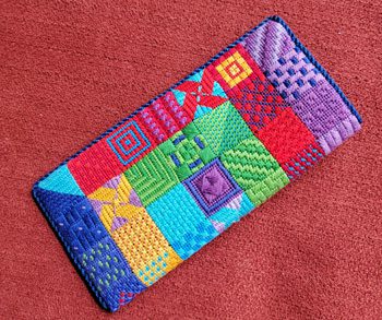 A colorful wallet sitting on top of the carpet.