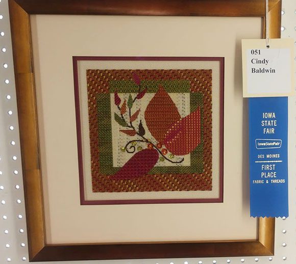 A framed picture of a quilt with the name of cindy baldwin.