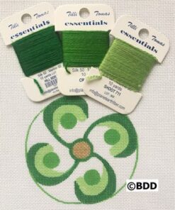 A green circle with four different colors of thread.