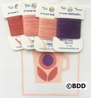 A set of four different colors of thread.