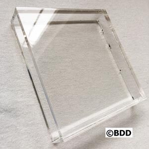 A clear square shaped object sitting on top of a table.