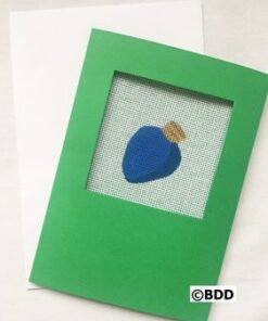 A green card with a blue piece of glass in it.