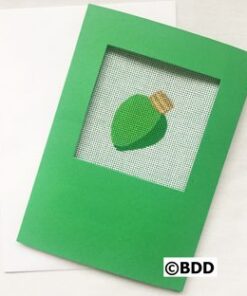A green card with an ornament in the middle of it.