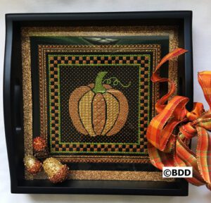 A black tray with a pumpkin on it