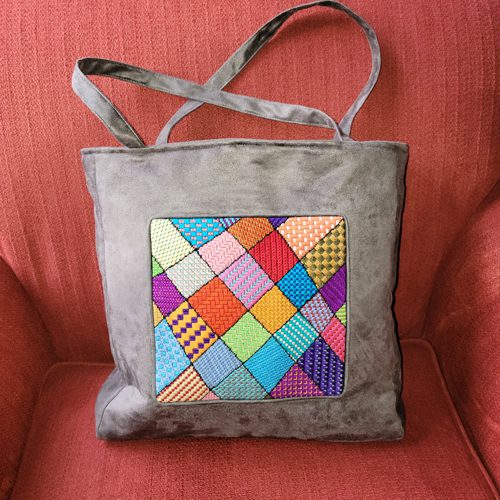 A bag with a patchwork design on it.