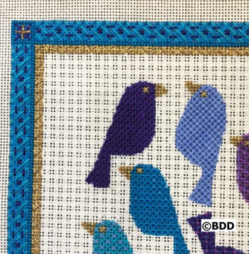 A close up of the birds on the quilt