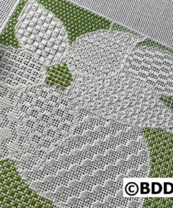 A close up of the fabric with green and white patterns.