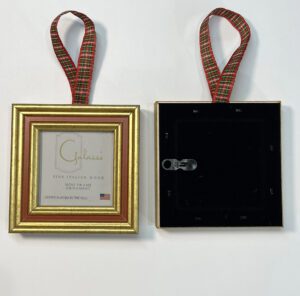 A gold frame with red ribbon hanging from the back.