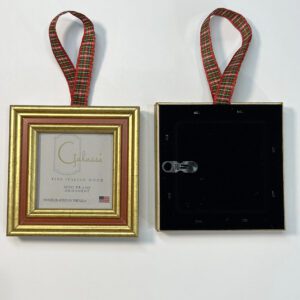 A gold frame with red ribbon hanging from the back.