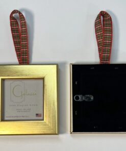 A gold frame with a red ribbon hanging from it.