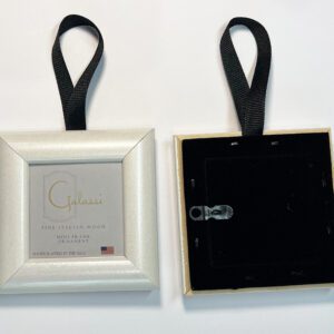 A picture frame hanging on a black ribbon.