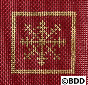 A red and gold cross stitch pattern with a snowflake.