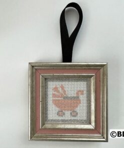 A framed picture of a baby carriage.