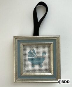 A framed cross stitch of a bathtub in blue.