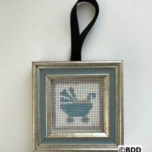 A framed cross stitch of a bathtub in blue.