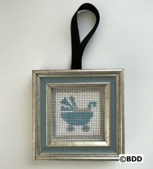 A framed cross stitch of a bathtub in blue.