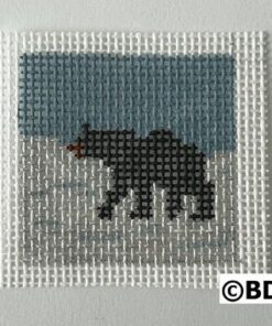 A bear walking across the snow covered ground.