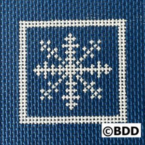 A blue fabric with white cross stitch on it.