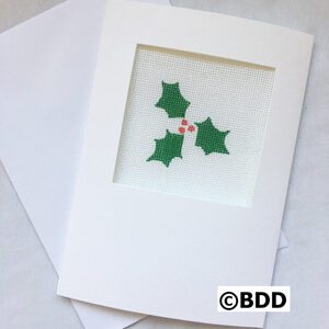 A white card with a picture of holly leaves.