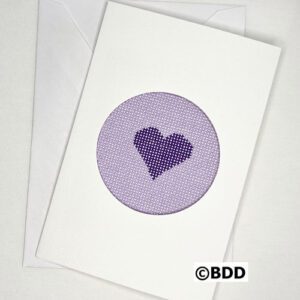 A purple heart is stitched on to the card.