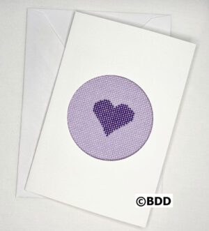 A purple heart is stitched on to the card.