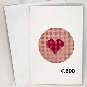 A card with a heart stitched on it.