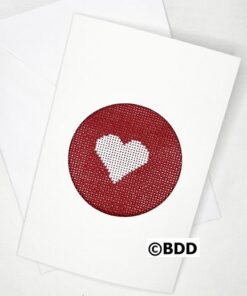 A red card with a white heart stitched on it.