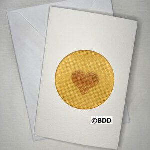 A card with a heart on it and an envelope.