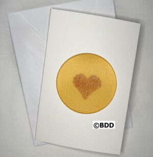 A card with a heart on it and an envelope.