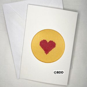 A card with a heart stitched on it.